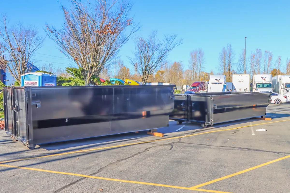 Professional dumpster rental service with roll-off container on residential driveway in Ripon